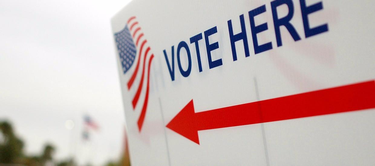 A sign which reads "Vote Here."