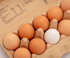 A carton of eggs on a table.