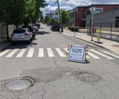 A road with a "shared street" sign.