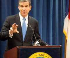 Governor Cooper speaking at a podium.