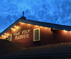 The Flat Rock Playhouse building at dusk.