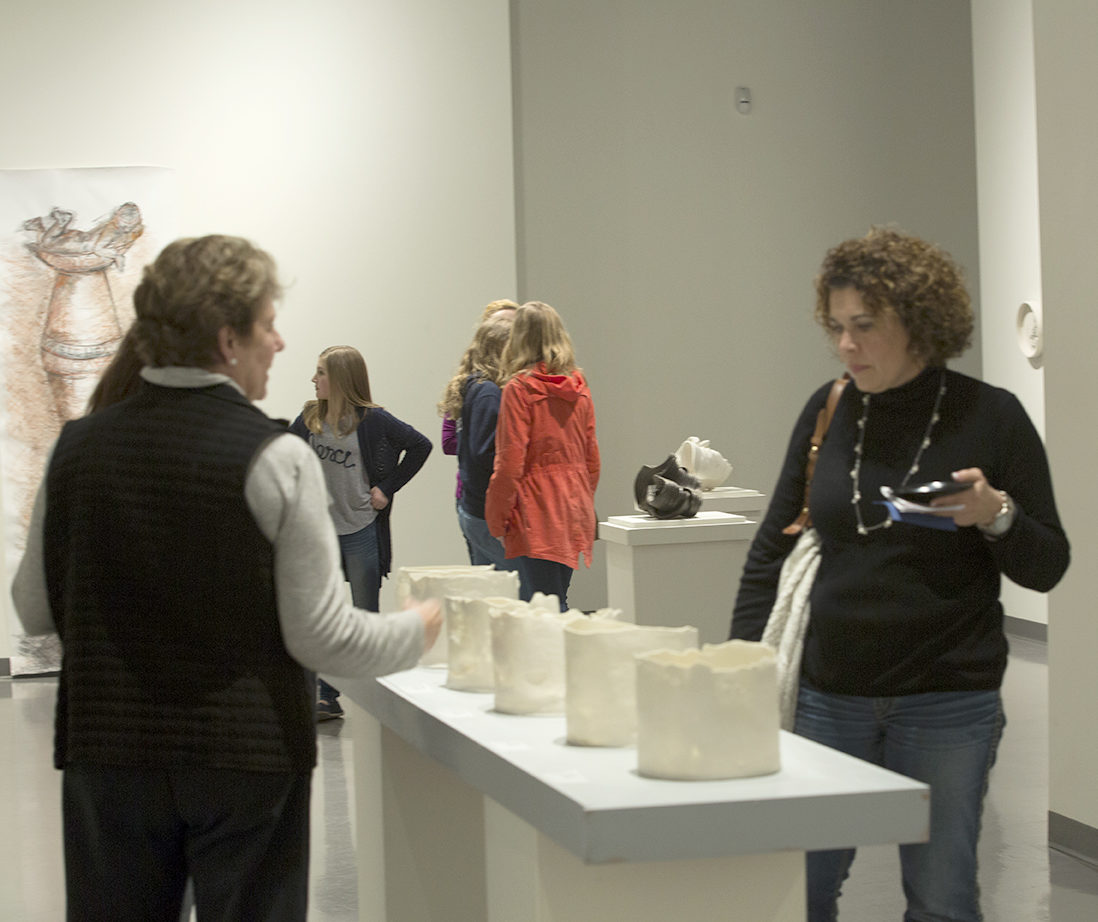 Spartanburg residents walking around a museum during ArtWalk.